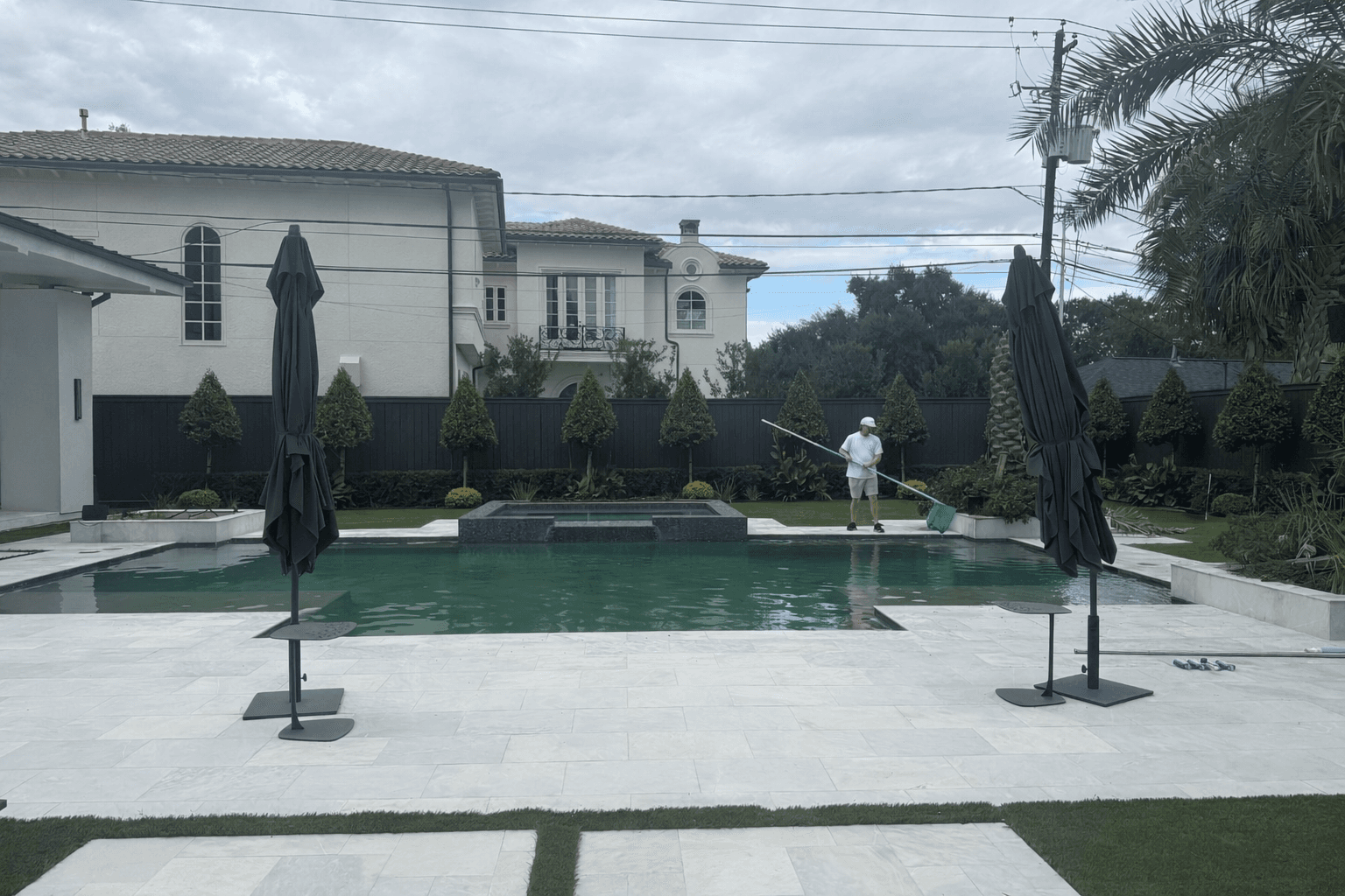 Professional pool cleaning service in Nashville. Surface skimming on a luxury residential pool